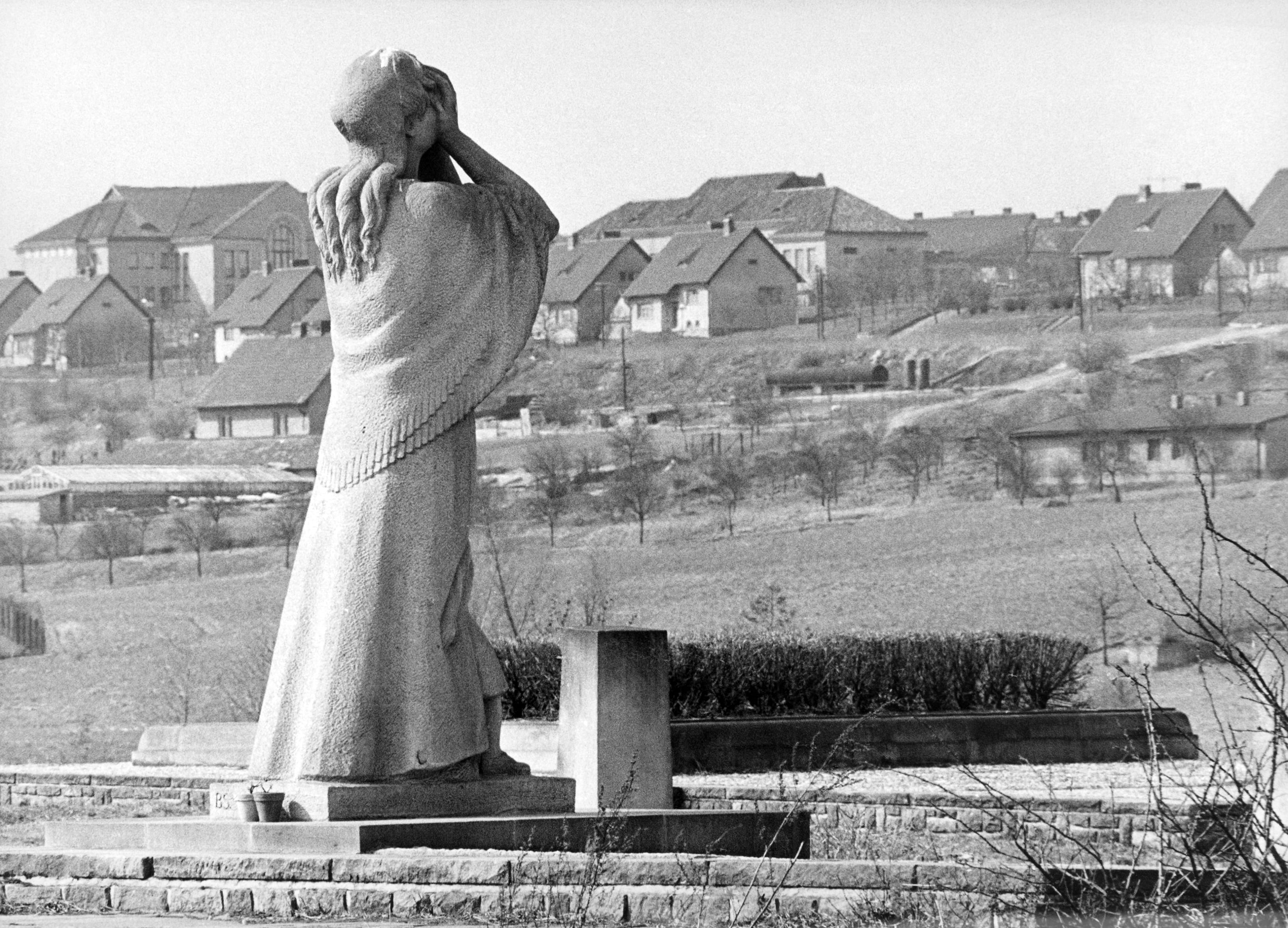 In the background is nove (new) Lidice on May 15, 1967, built after the war. In the foreground is the statue of a woman protecting her face from flames on the site of the village school, burned by Nazi troops. (AP Photo)
